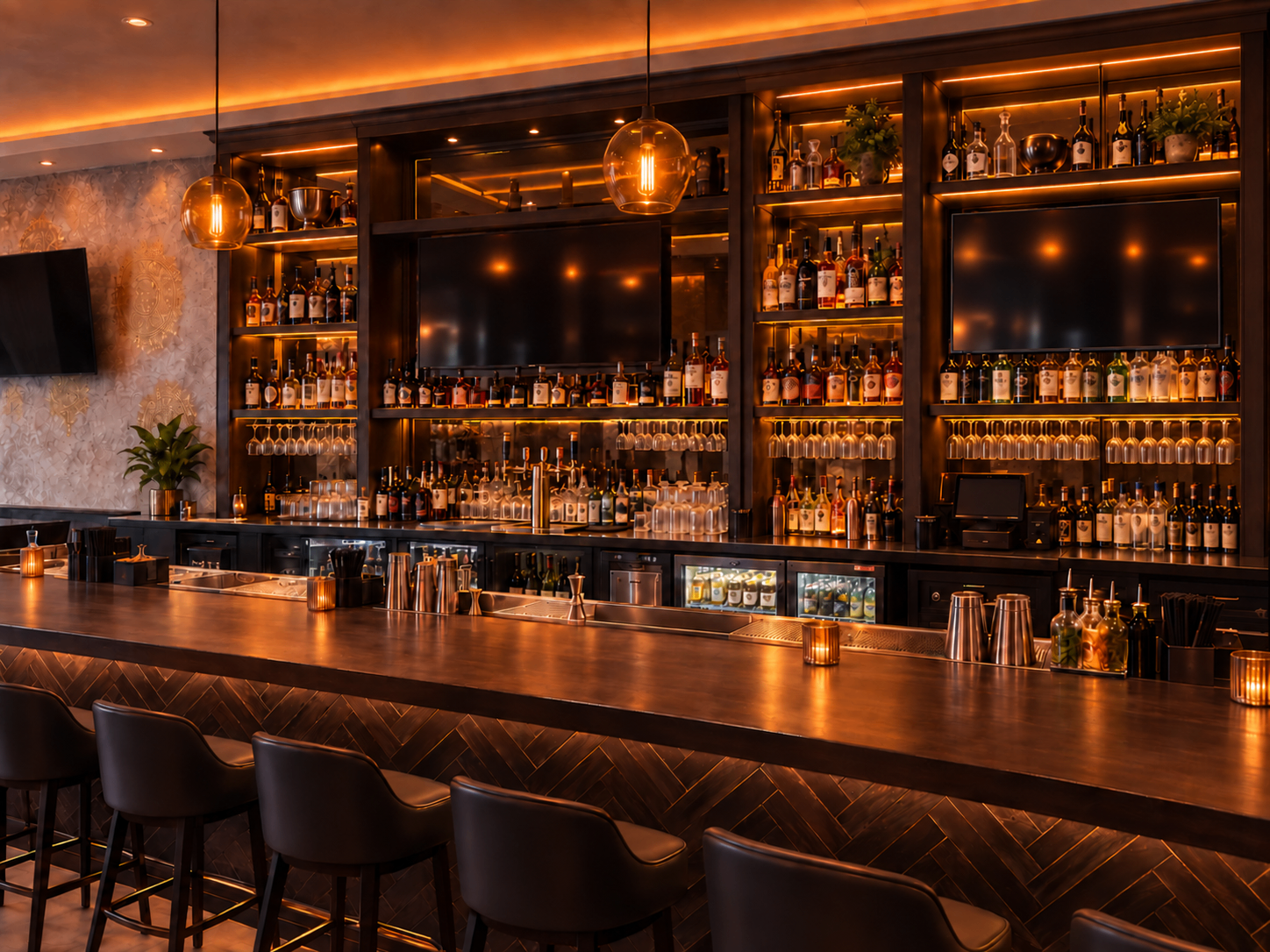 The candlelit bar at Love Story Brooklyn, with warm lighting, stocked shelves and seating for cocktails